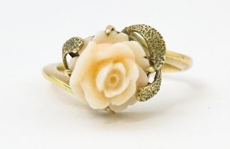 A 14ct gold ring set with carved floral detail. Ring size approx. Q Please Note - we do not make