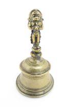 An Indian brass bell the handle modelled as a stylised Hanuman. Approx. 5 3/4" high Please Note - we