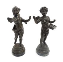 A pair of 20thC Continental cast putti figures after Henryk Kossowski, raised on circular marble