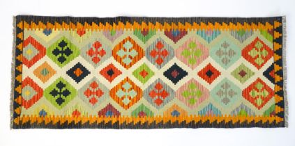 Carpet / Rug : A Turkish Anatolian kilim decorated with repeating geometric motifs Approx. 78" x 32"