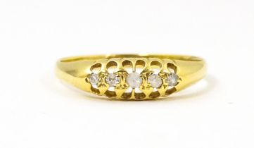 A 9ct gold ring set with five diamonds and white stones. Ring size approx. M Please Note - we do not