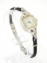 A ladies 14k white gold cased Bulova cocktail wristwatch set with diamonds. Watch case approx. 1/