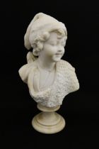 A composite marble / alabaster bust after Guglielmo Pugi depicting a young boy. Signed to reverse.