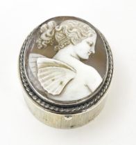 A silver pill box with shell carved cameo to lid depicting a fairy, hallmarked Chester 1904, maker