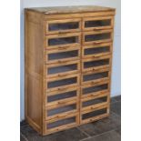 Shop Cabinet. An early 20th century oak haberdashery bank of 16 drawers