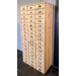 Shop Cabinet. An early 20th century pine shop keepers bank of 48 drawers