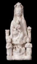 Blanc de Chine Guanyin porcelain figural group, Qing, circa 1670