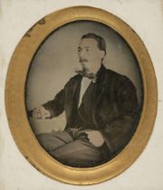 Ambrotype. A hand-tinted ambrotype of a man seated at a table smoking, probably Spanish, c. 1850s