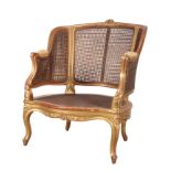 A 19TH CENTURY GILTWOOD BERGERE FAUTEIL OF OVERSIZE PROPORTIONS