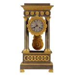 A 19TH CENTURY FRENCH GILT METAL EMPIRE PORTICO CLOCK