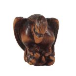 A JAPANESE CARVED WOOD NETSUKE SIGNED HIDEHISA