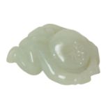 A CHINESE PALE CELADON JADE CARVING OF A BOY