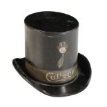 AN EDWARDIAN METAL TOP HAT MONEY BOX