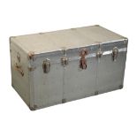 AN ALUMINIUM STUDDED TRAVELLING TRUNK