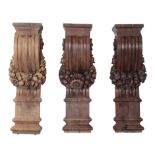 A GROUP OF THREE BAROQUE OAK WALL BRACKETS OR PILASTERS