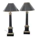 A PAIR OF EBONISED AND GILT METAL MOUNTED COLUMNAR TABLE LAMPS