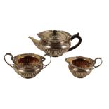 A LATE VICTORIAN SILVER THREE PIECE TEA SERVICE