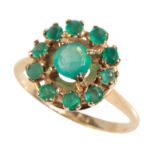 AN EMERALD CLUSTER DRESS RING