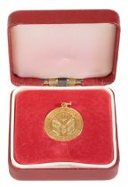 AN 18CT GOLD MEDAL