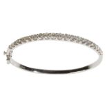 A HALF-SET DIAMOND BANGLE