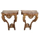 A PAIR OF LOUIS XV STYLE GILTWOOD AND MARBLE TOPPED CONSOLE TABLES