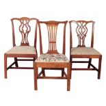 AN ASSOCIATED GROUP OF THREE GEORGE III MAHOGANY DINING CHAIRS