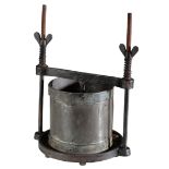 A CAST METAL CHEESE PRESS