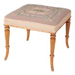 A REGENCY STYLE SATINWOOD AND PARCEL GILT STOOL