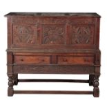 A CHARLES II STYLE OAK CHEST ON STAND