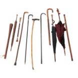 A COLLECTION OF WALKING STICKS AND PARASOLS