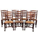 A MATCHED SET OF SEVEN LADDER BACK DINING CHAIRS