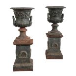 A PAIR OF CAST IRON URNS