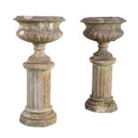 A PAIR OF RECONSTITUTED STONE URNS