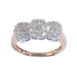 AN 18CT GOLD AND DIAMOND TRIPLE FLORAL CLUSTER RING