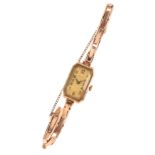 GENEX: A LADY'S 14CT GOLD BRACELET WATCH