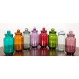 A SET OF EIGHT COLOURED AND MOULDED GLASS SWEET JARS AND COVERS