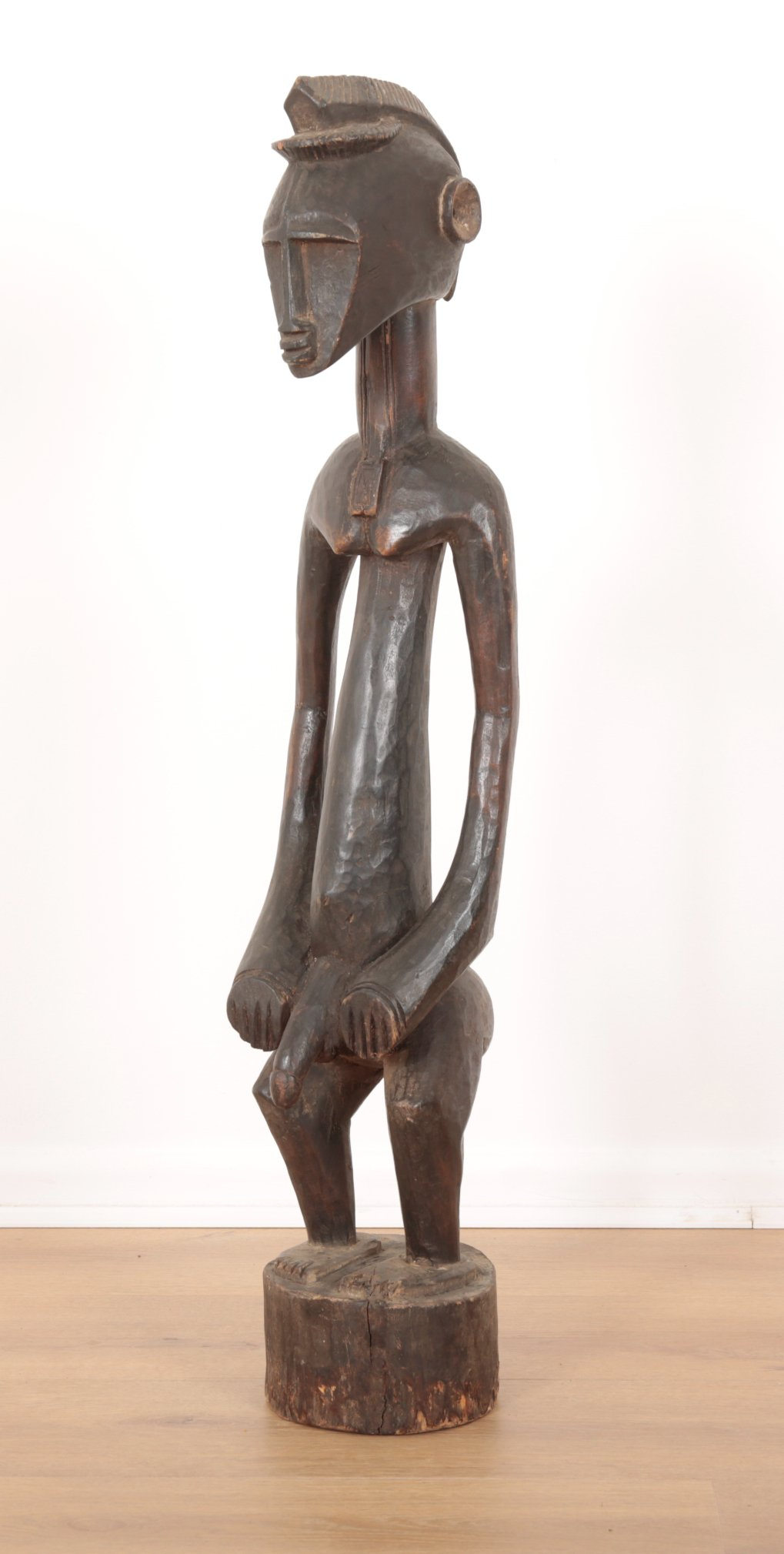 AN AFRICAN CARVED WOOD FIGURE