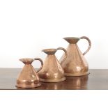 A GROUP OF THREE GRADUATED COPPER JUGS