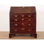 AN EARLY GEORGE III MAHOGANY BUREAU