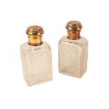 A PAIR OF GEORGE V SILVER GILT SCENT OR TOILET BOTTLES