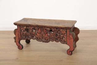 A TIBETAN CARVED AND PAINTED LOW TABLE OR CHOGTSE