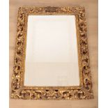 A CONTINENTAL CARVED GILTWOOD MIRROR