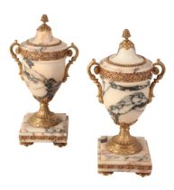 A PAIR OF NEOCLASSICAL PINK AND GREY MARBLE AND GILT METAL MOUNTED URNS