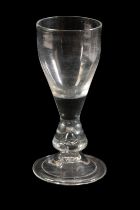 AN EARLY 18TH CENTURY ENGLISH WINE GLASS