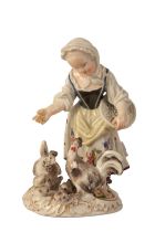 A MEISSEN PORCELAIN FIGURE OF A GIRL FEEDING A CHICKEN