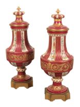 A LARGE PAIR OF SEVRES PORCELAIN URNS AND COVERS