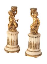 AFTER CLODION (1738-1814), A PAIR OF ORMOLU AND WHITE MARBLE CANDLESTICKS