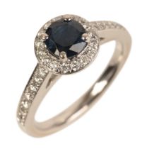 AN 18CT WHITE GOLD SAPPHIRE AND DIAMOND HALO RING