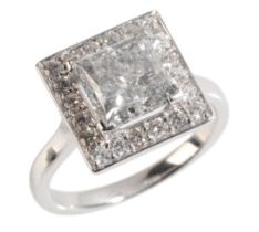 A PRINCESS CUT DIAMOND RING SET WITH A DIAMOND HALO