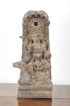 AN INDIAN CARVED AND POLYCHROME PAINTED FIGURE OF A DEITY